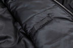 Black bomber jacket arm section with seam stitching and pocket flap detail