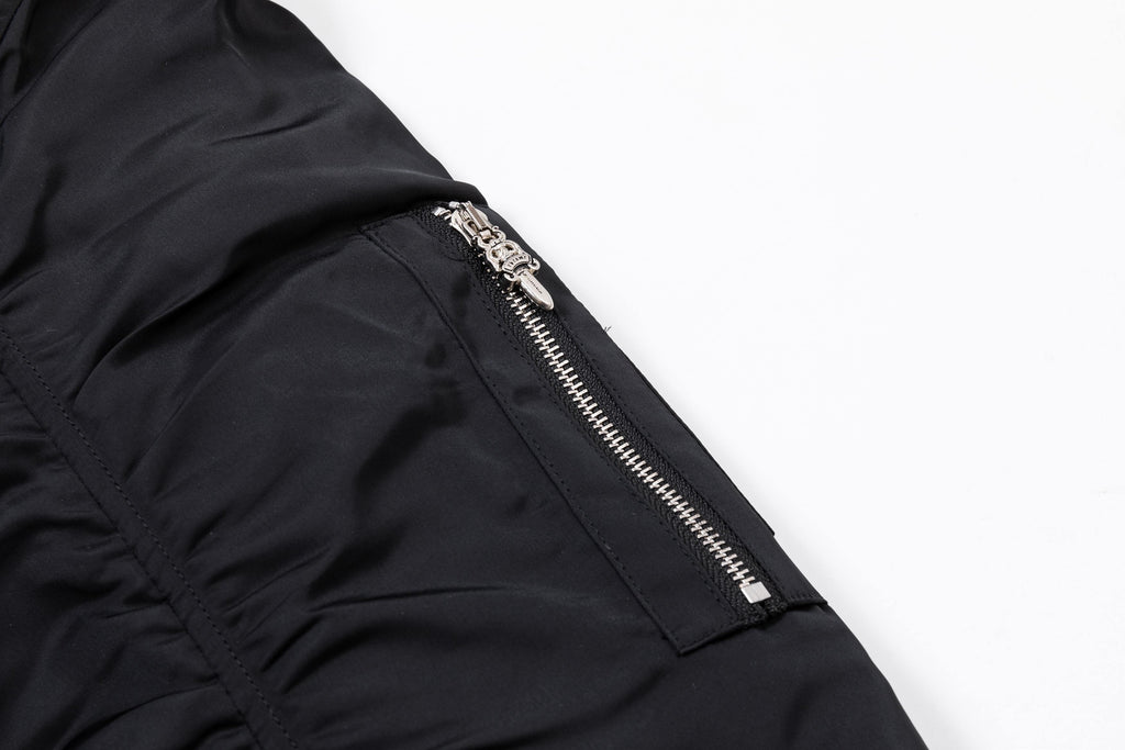 Black bomber jacket side zipper with silver hardware on sleeve