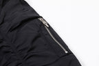 Black bomber jacket side zipper with silver hardware on sleeve