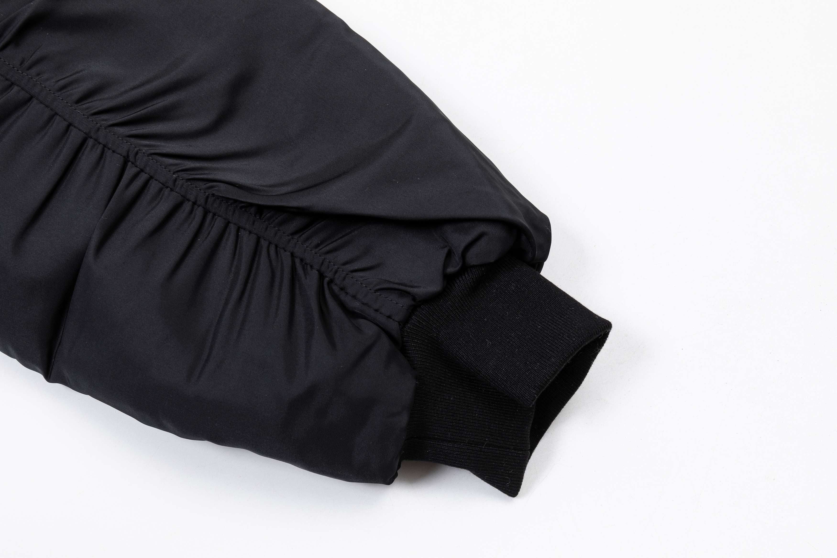 Black long pants with elastic waistband and gathered cuffs