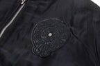 Black bomber jacket with large circular chest applique and textured stitching