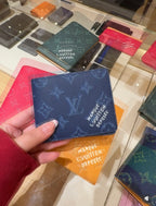 Louis Vuitton small pouch with blue monogram pattern, held in hand