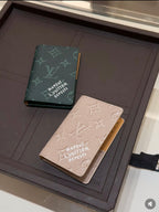 Louis Vuitton small pouches with green and light beige monogram prints on tray