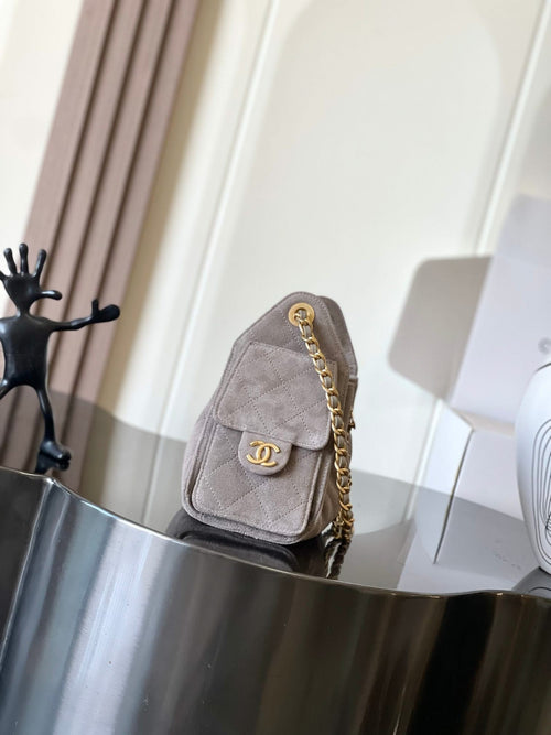 Chanel flap bag in light gray with gold chain strap and turn-lock clasp