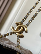 Chanel gold chain and clasp hardware on light gray flap edge