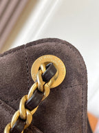 Brown suede with gold turn-lock hardware featuring an engraved logo