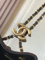 Gold link chain with dark strap connection and metal clasp hardware