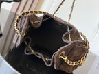 Dark brown suede shoulder bag open with gold chain strap and dark interior