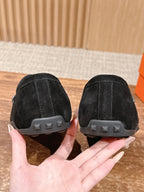 Hermes unisex black suede loafers heel view with molded rubber sole tread