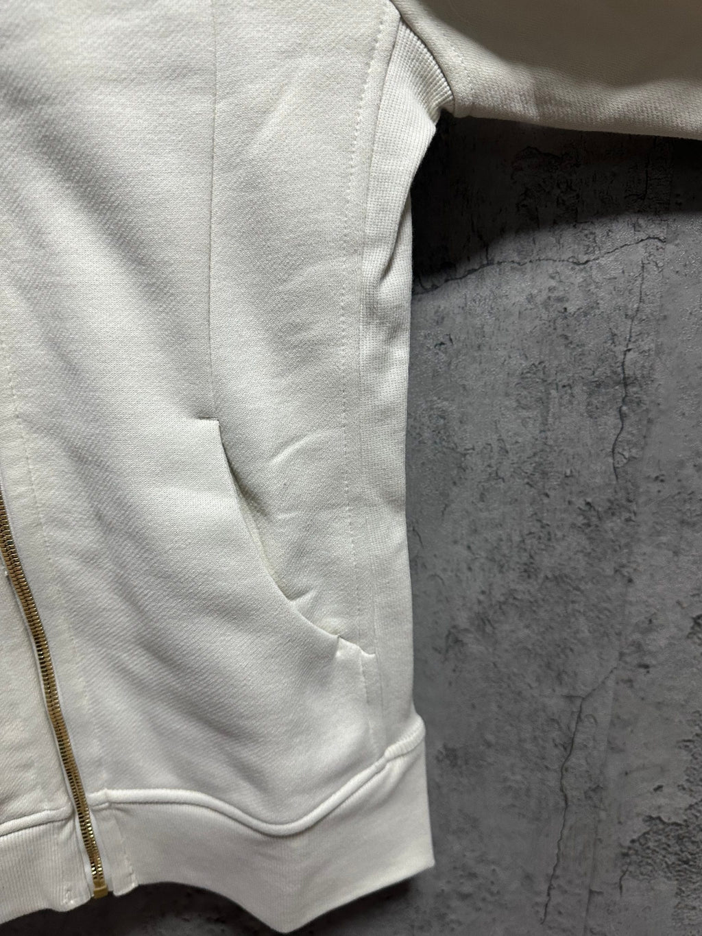 Ralph Lauren light cream hoodie side view with pocket seam and front zipper
