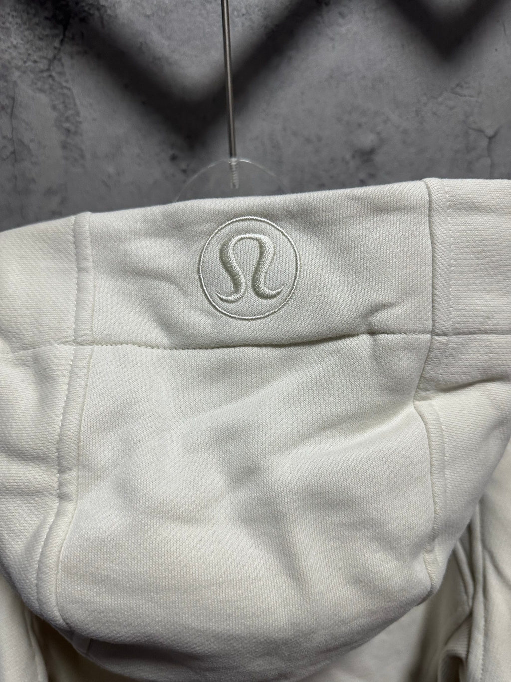 Ralph Lauren hoodie hood logo patch in light cream, front zipper edge visible