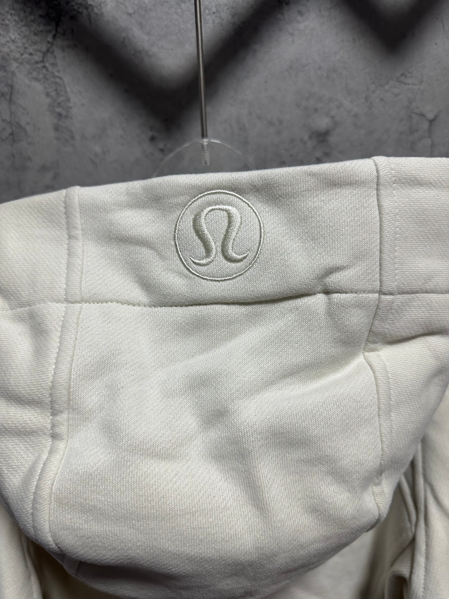 Ralph Lauren hoodie hood logo patch in light cream, front zipper edge visible
