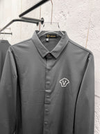 Versace button-up dress shirt, grey with crest logo and pointed collar.