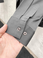 Versace shirt cuff with two button closures, grey fabric.