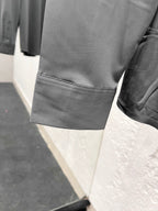 Versace shirt sleeve with stitched cuff edge, grey button-up.