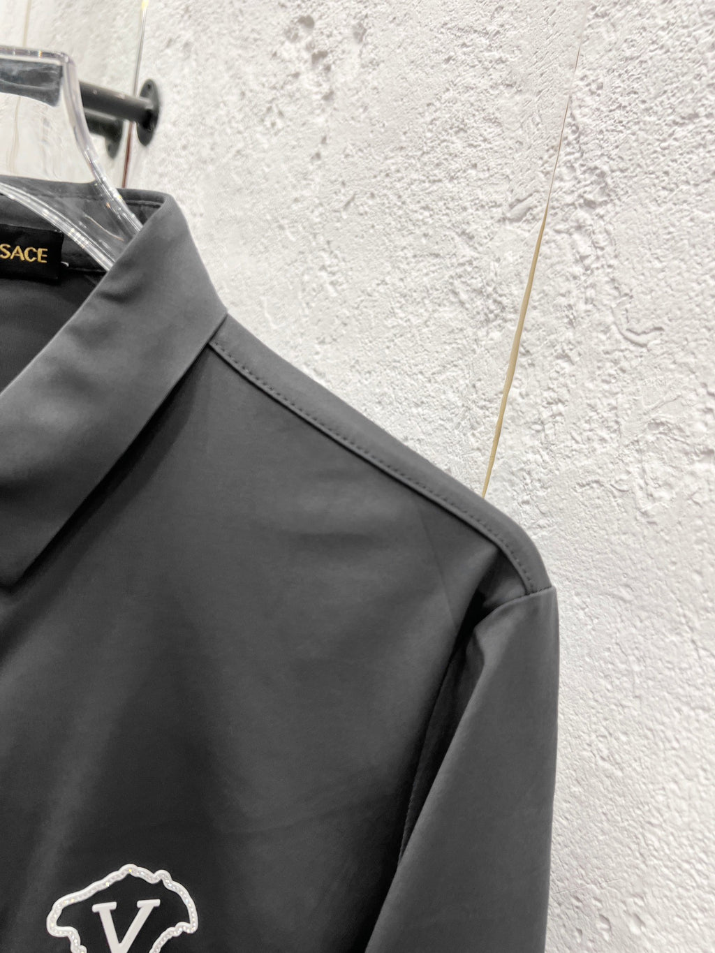 Versace button-up shirt collar and shoulder seam, grey.
