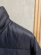 Prada puffer jacket shoulder and upper sleeve seam detail, dark padded fabric