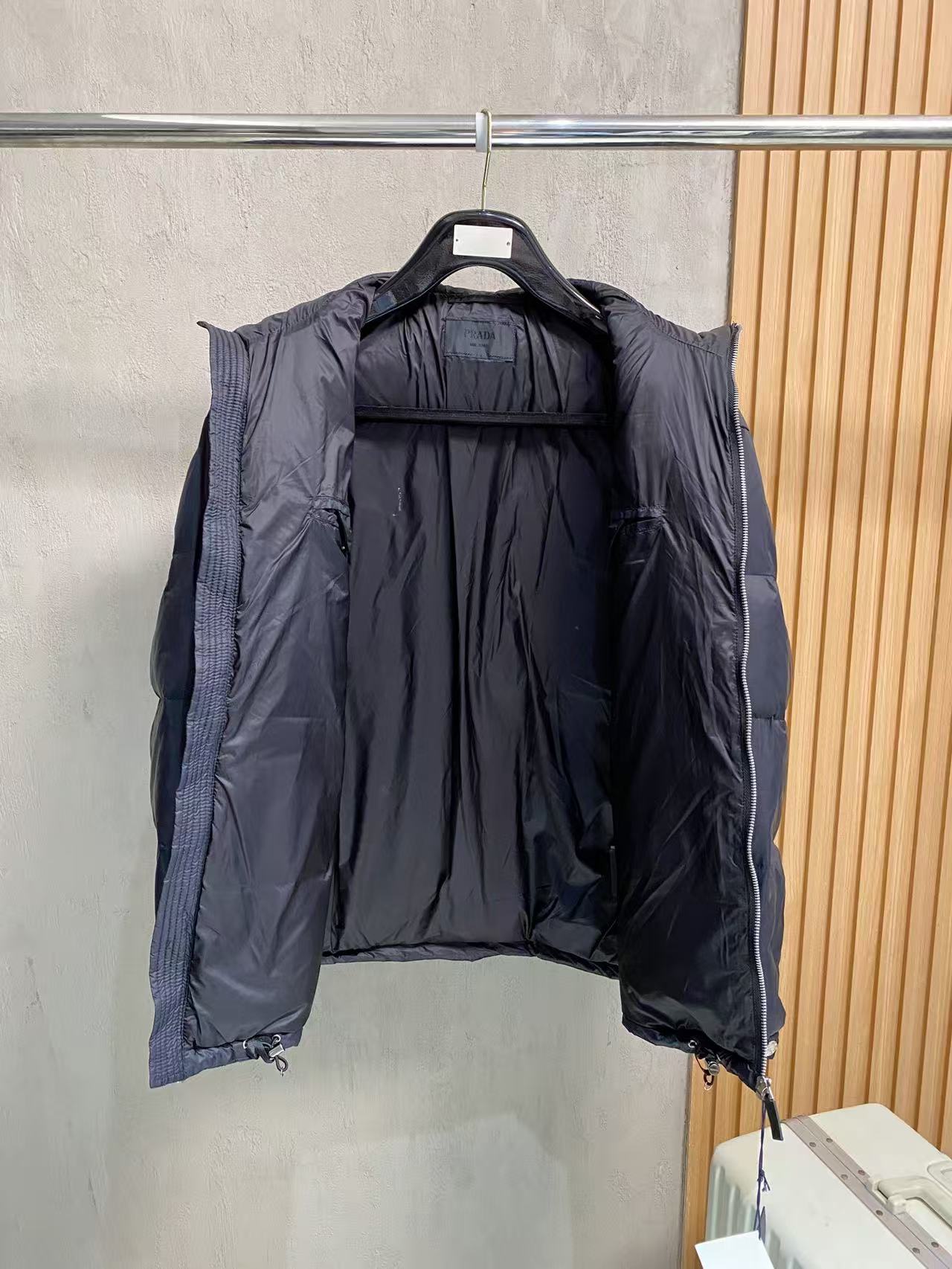 Prada puffer jacket open back view with dark padded lining