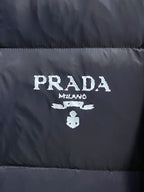 Prada logo on front of puffer jacket, white branding on dark fabric