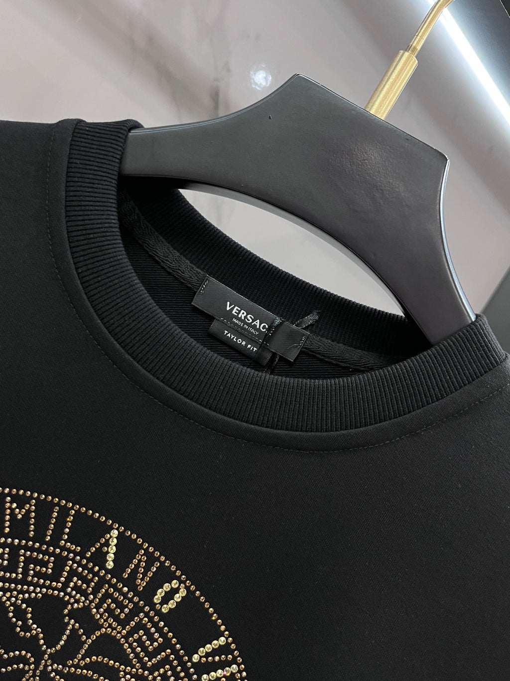 Versace crewneck collar detail in dark fabric with inner neck label