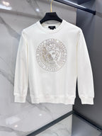 White crewneck sweatshirt with silver-tone studded circular logo graphic on chest
