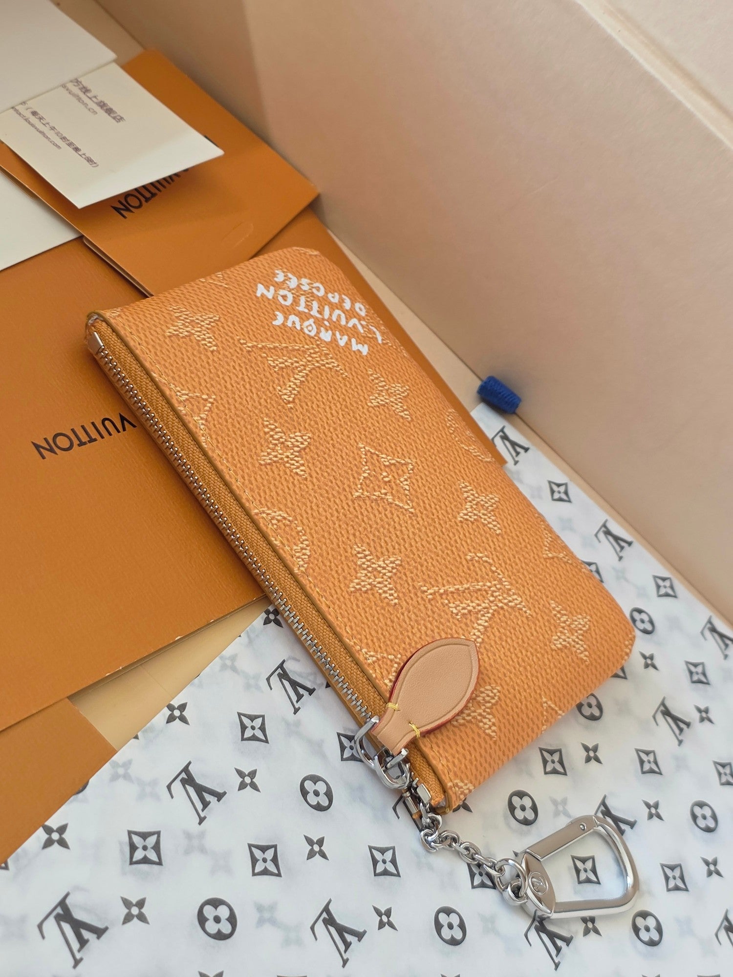 Small Louis Vuitton monogram bag with zip closure and side keyring hardware