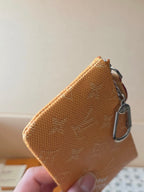 Small Louis Vuitton monogram bag side view with chain and metal clasp