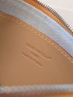 Small Louis Vuitton bag interior label on tan lining, "LOUIS VUITTON" stamp