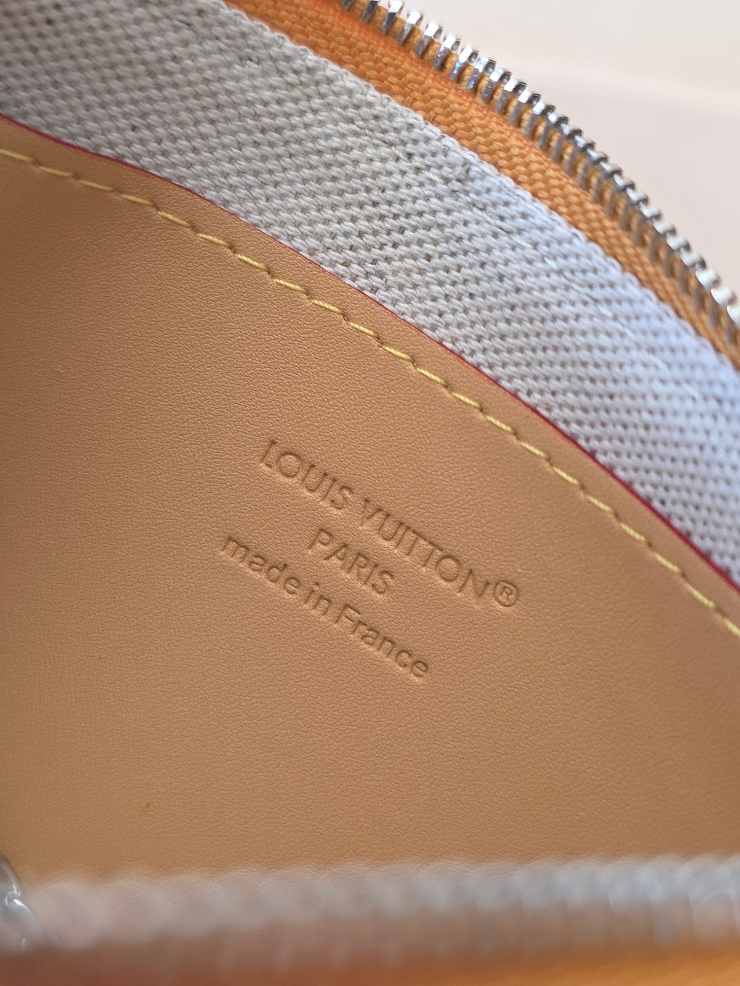 Louis Vuitton zip pouch interior label with “Louis Vuitton” and “Made in France”