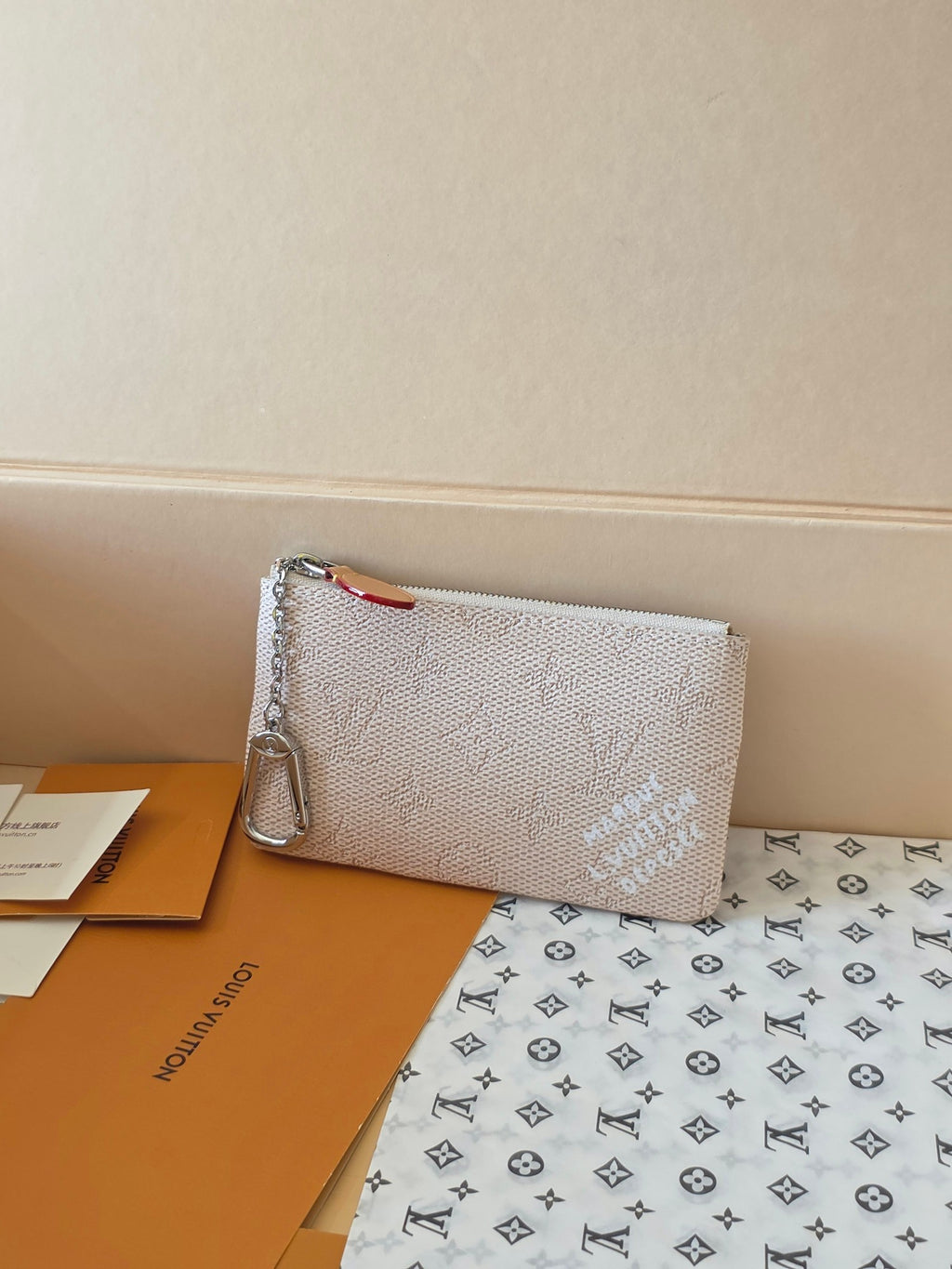 Small zip pouch in light beige textured canvas with monogram print and silver zipper