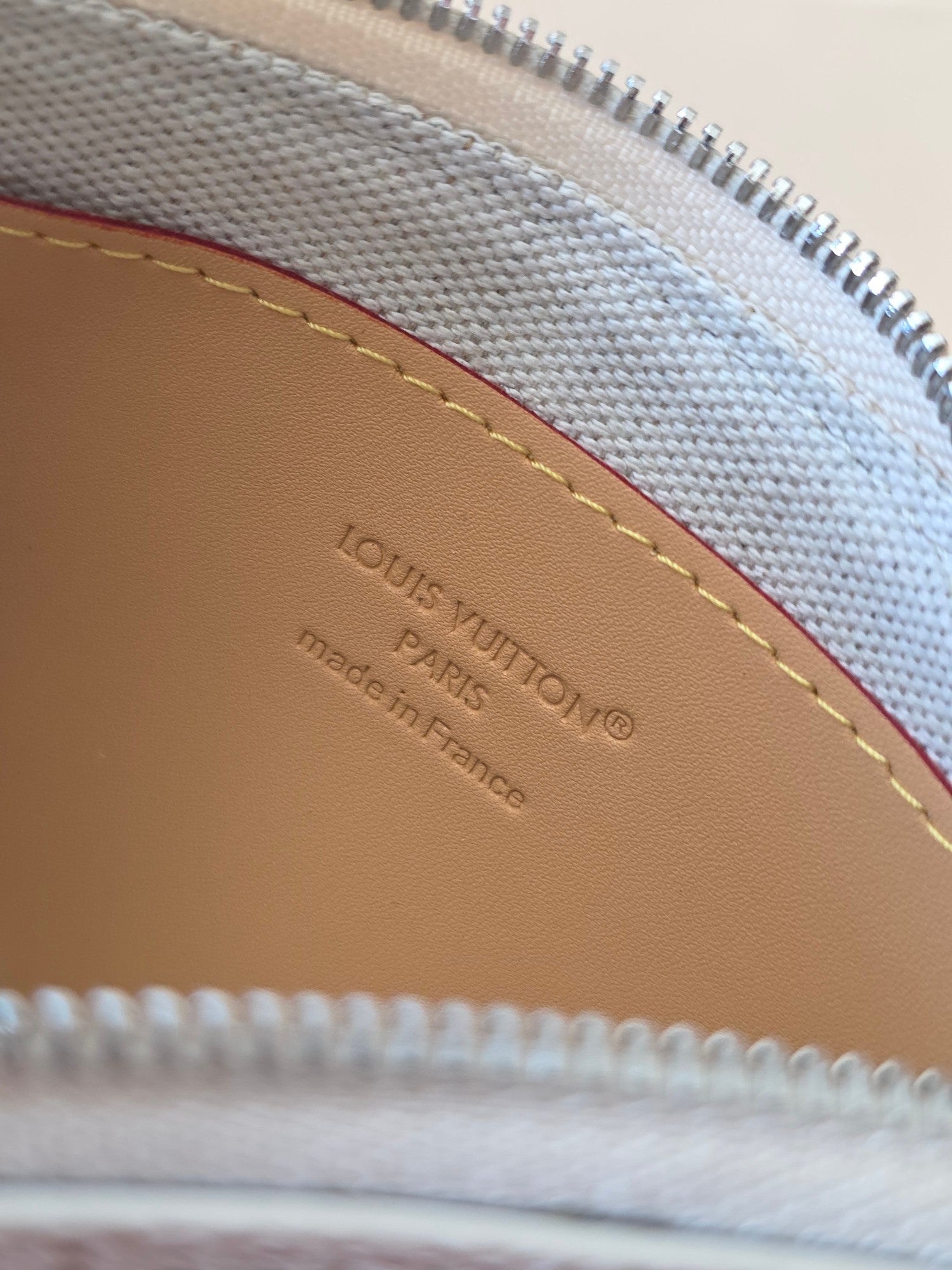 Tan leather interior patch with embossed LOUIS VUITTON and Made in France