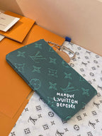 Louis Vuitton small bag with teal monogram canvas, chain handle, and zipper closure