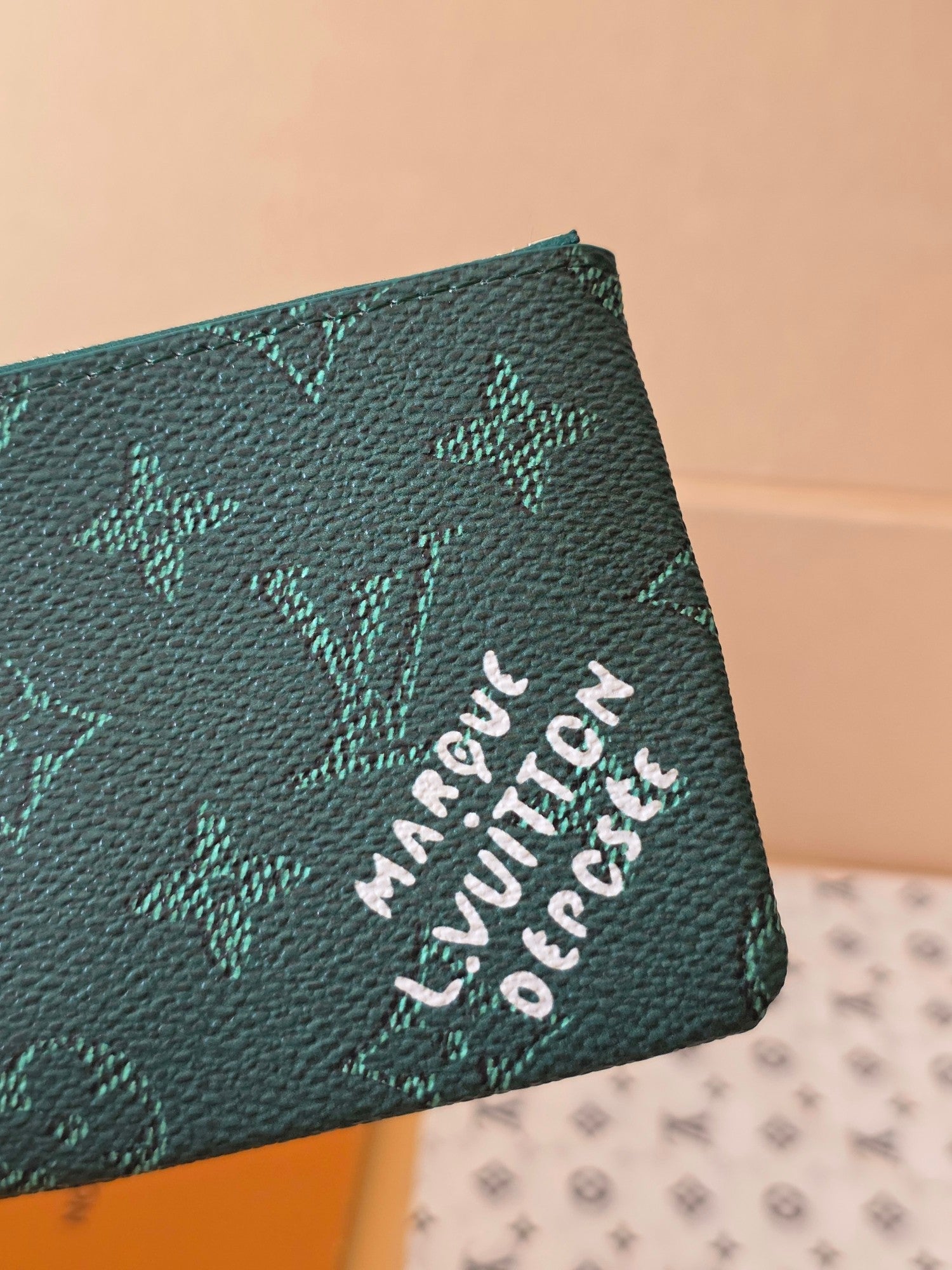 Louis Vuitton small bag with teal monogram canvas and white embroidered-style lettering
