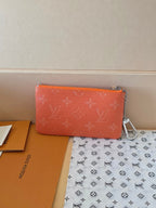 Orange monogram small zip pouch with silver chain strap and flat front