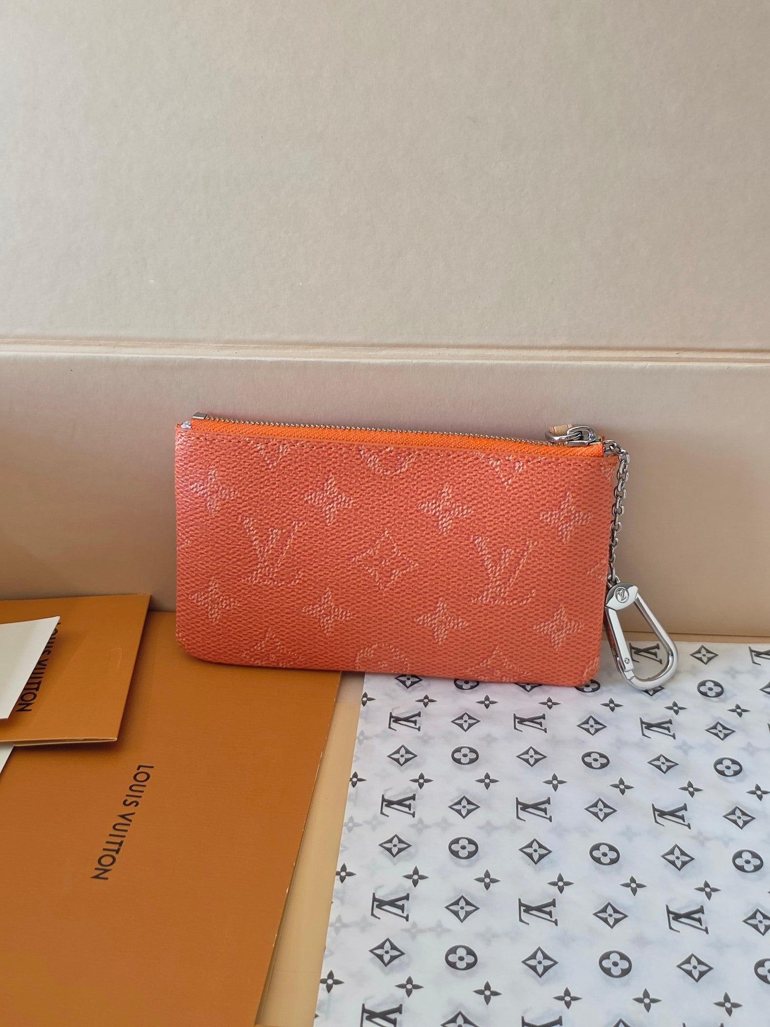 Orange monogram small zip pouch with silver chain strap and flat front