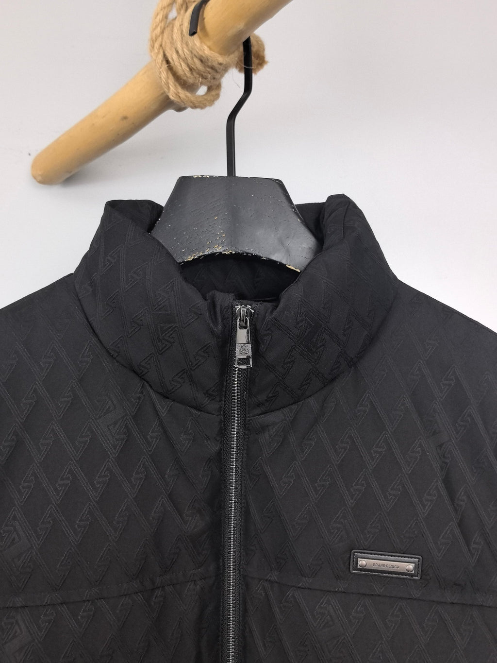 Black Burberry quilted jacket front detail with logo patch and zipper