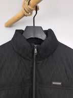 Black Burberry quilted jacket front detail with logo patch and zipper