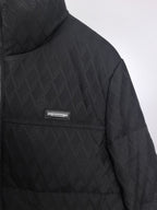 Black Burberry quilted jacket side view with chest logo patch