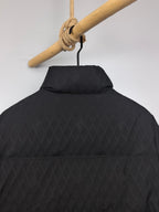 Black quilted jacket with stand collar and textured pattern