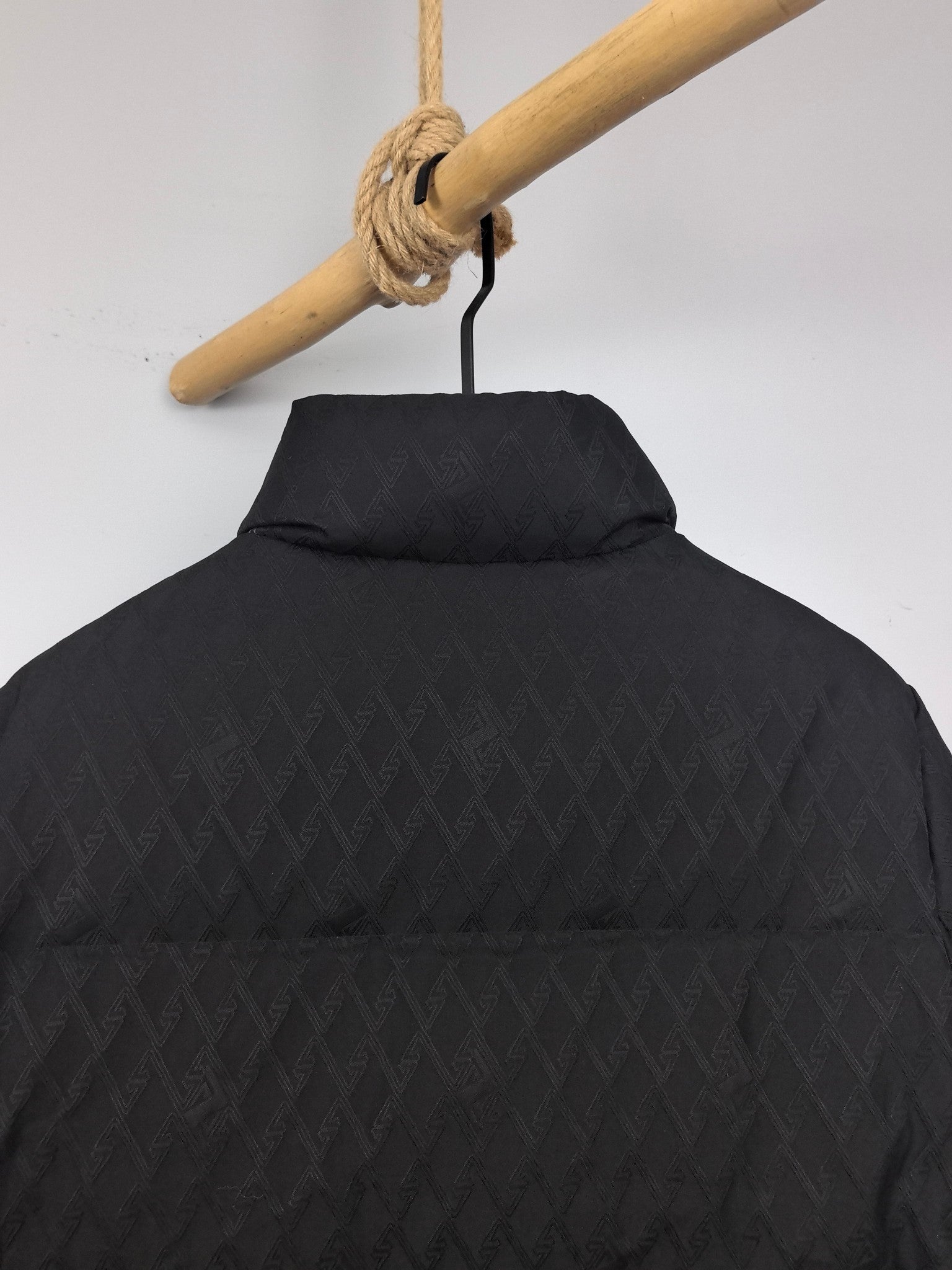 Black quilted jacket with stand collar and textured pattern