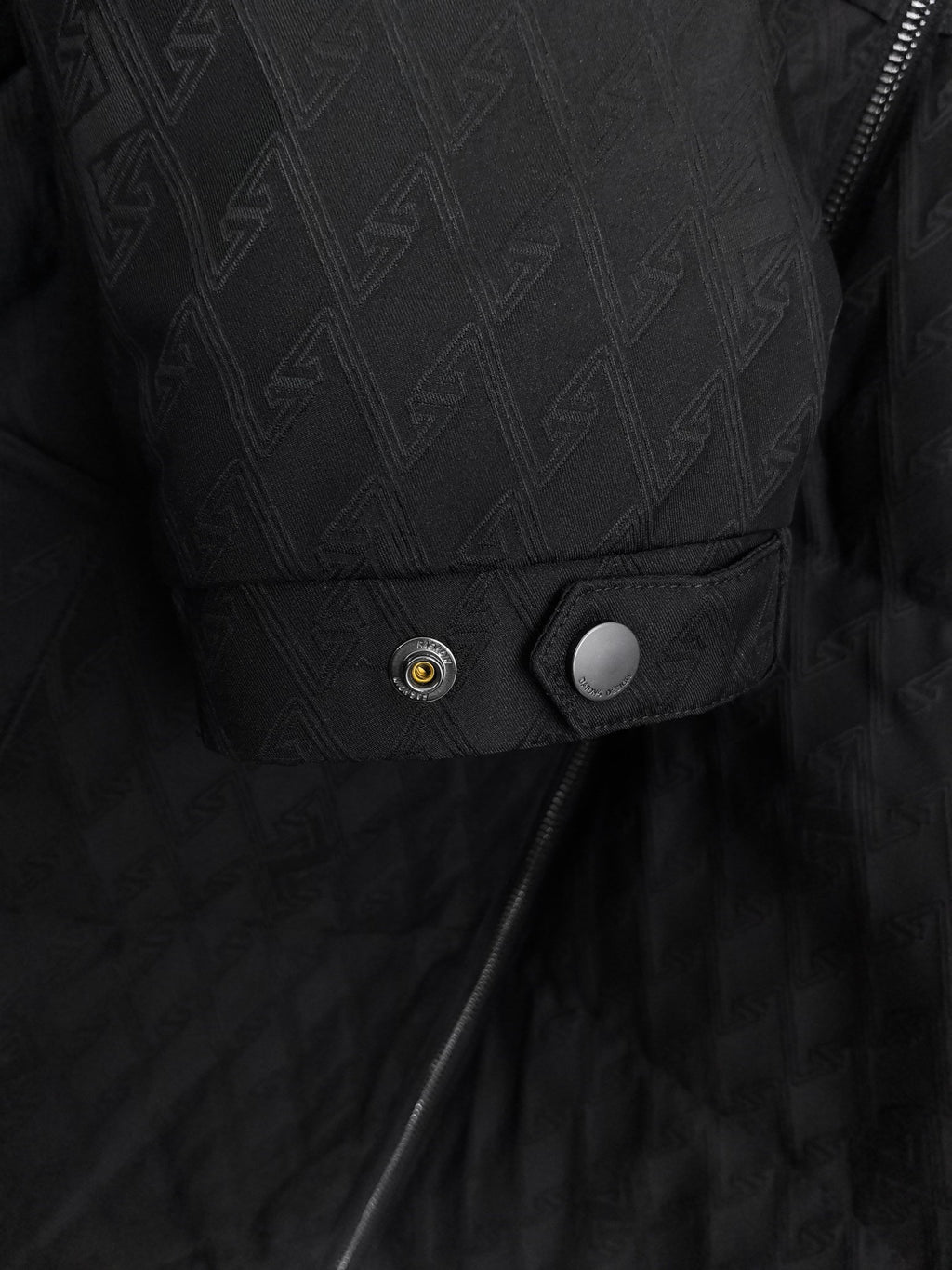 Black quilted jacket pocket and snap-button placket detail