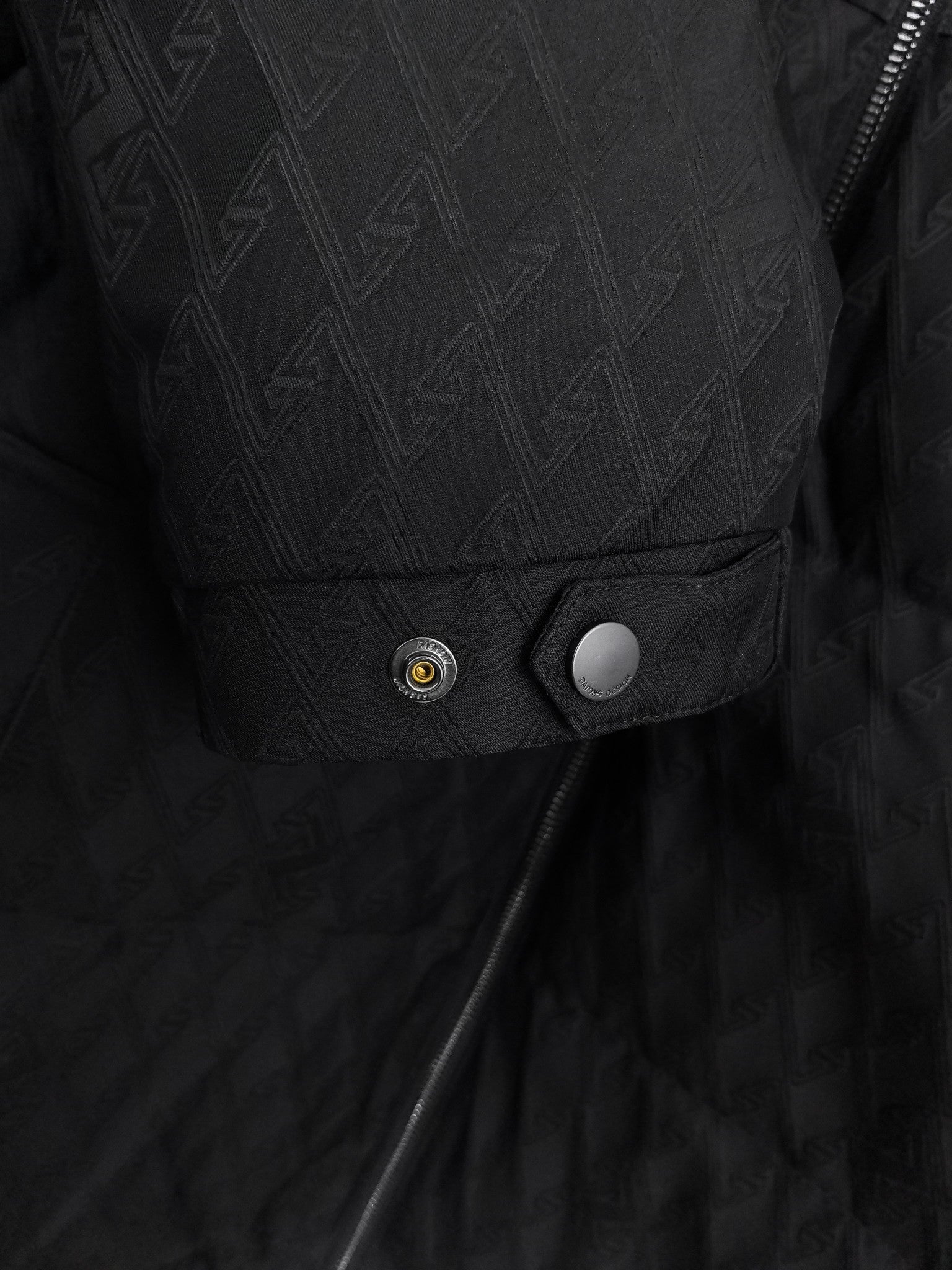 Black quilted jacket pocket and snap-button placket detail