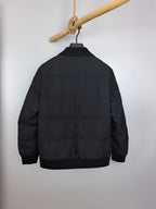 Louis Vuitton black quilted jacket, back view with ribbed knit collar