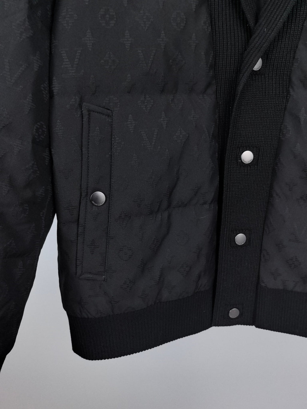 Louis Vuitton black quilted jacket front with flap pockets and snap buttons