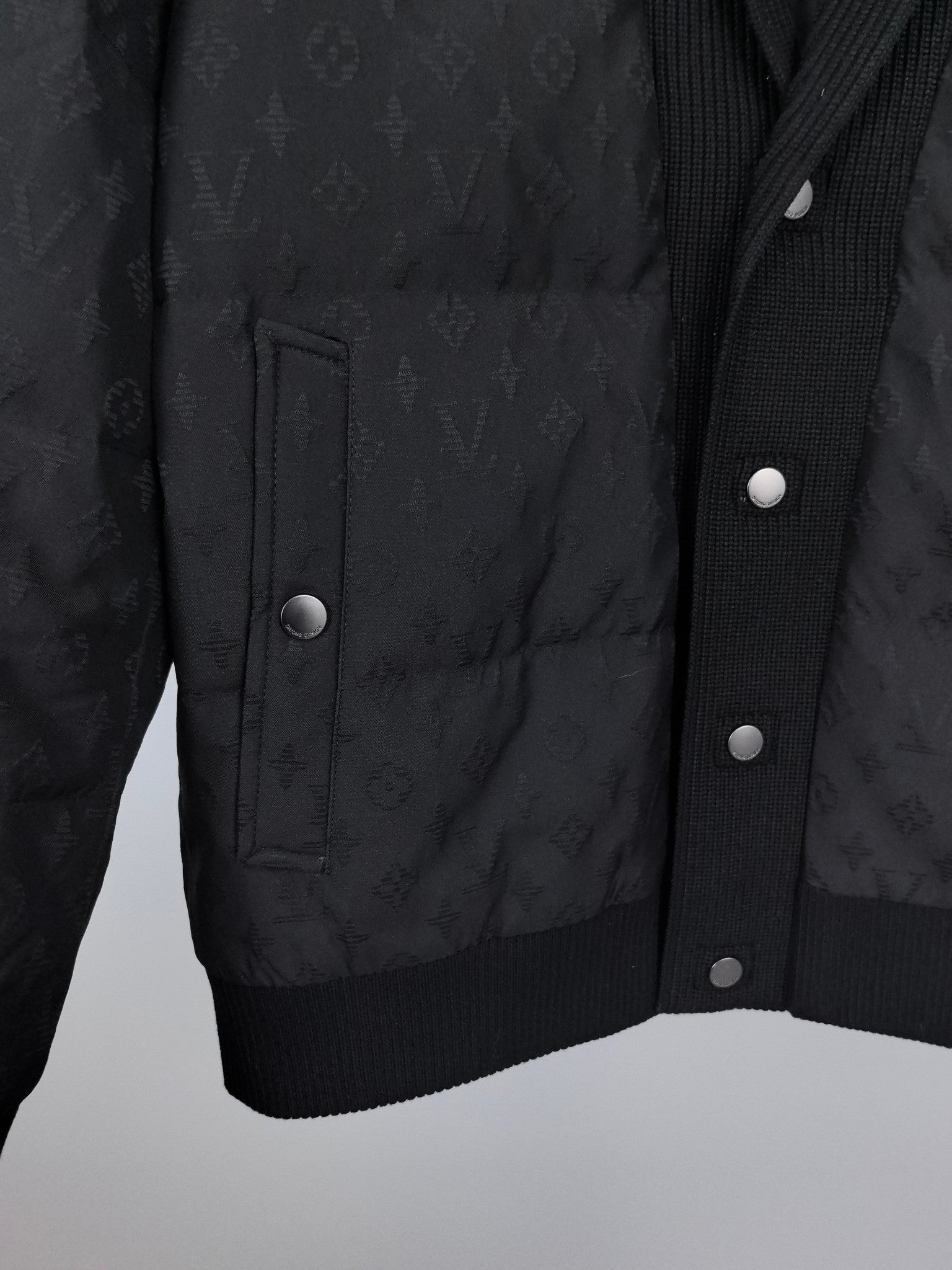Louis Vuitton black quilted jacket front with flap pockets and snap buttons