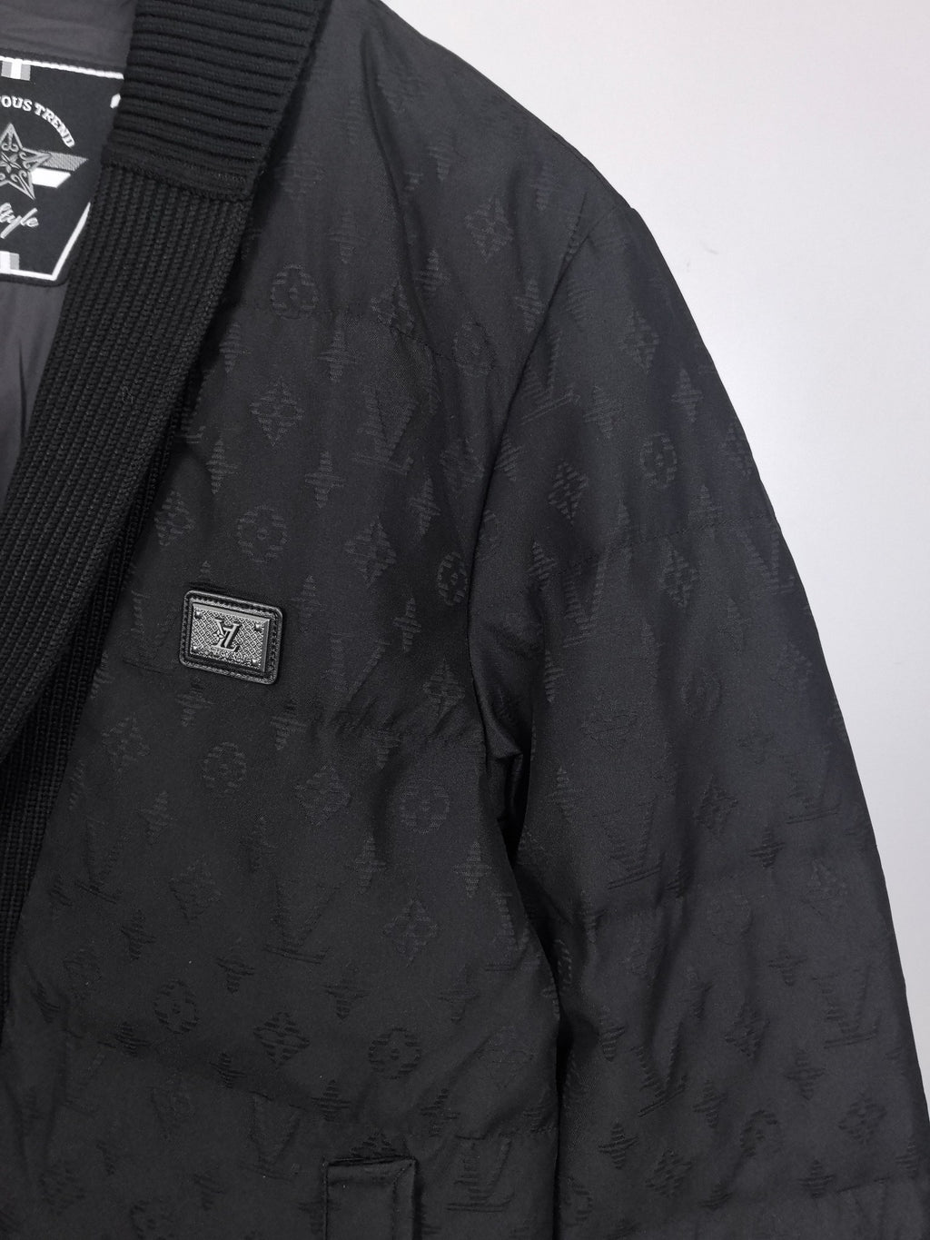 Louis Vuitton black quilted jacket side with small logo patch