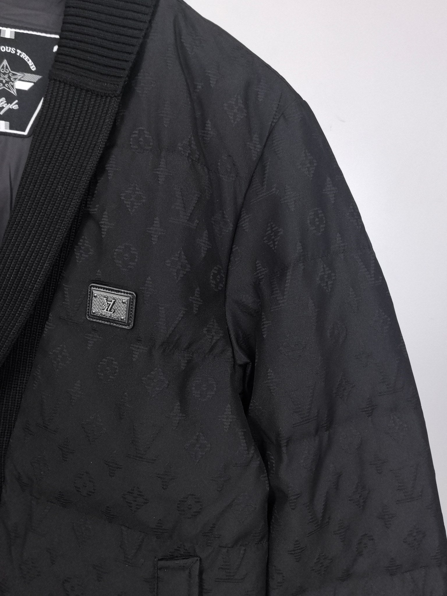 Louis Vuitton black quilted jacket side with small logo patch