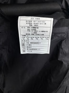 Garment care label inside black quilted jacket