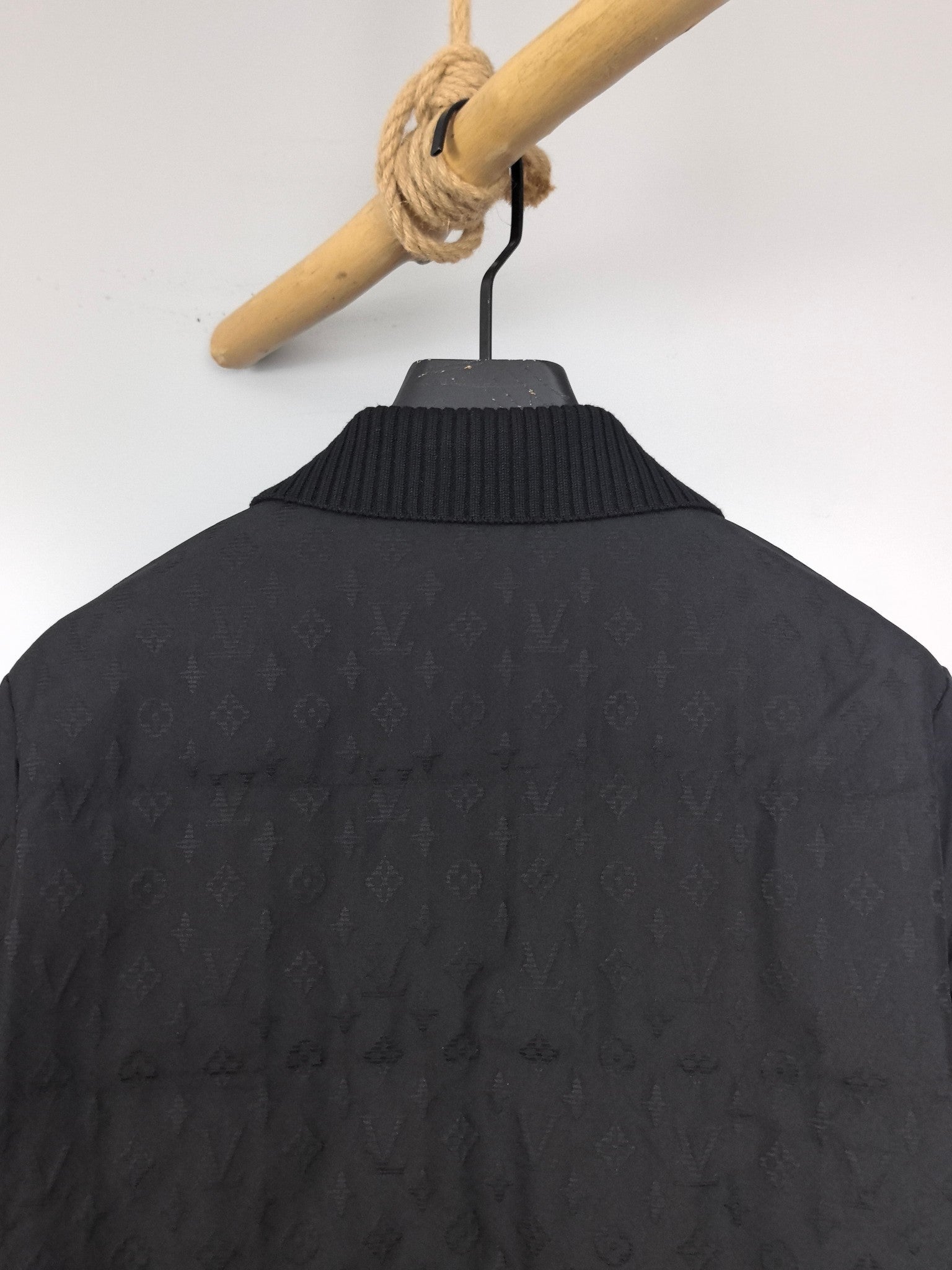 Louis Vuitton black quilted jacket back close-up with ribbed knit collar