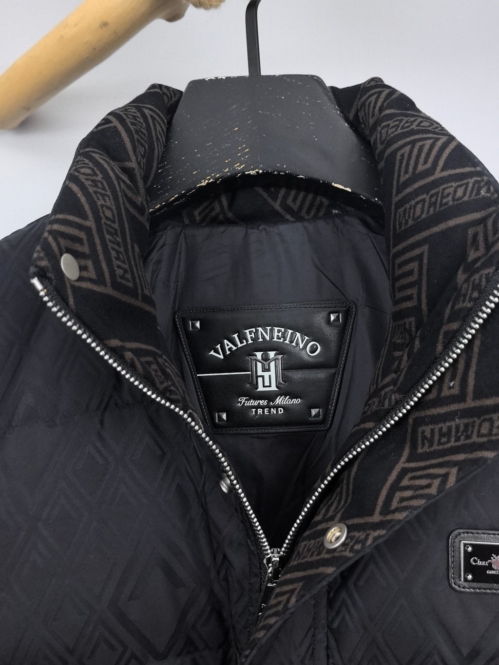Black puffer jacket hood lining detail with Valentino brand label inside